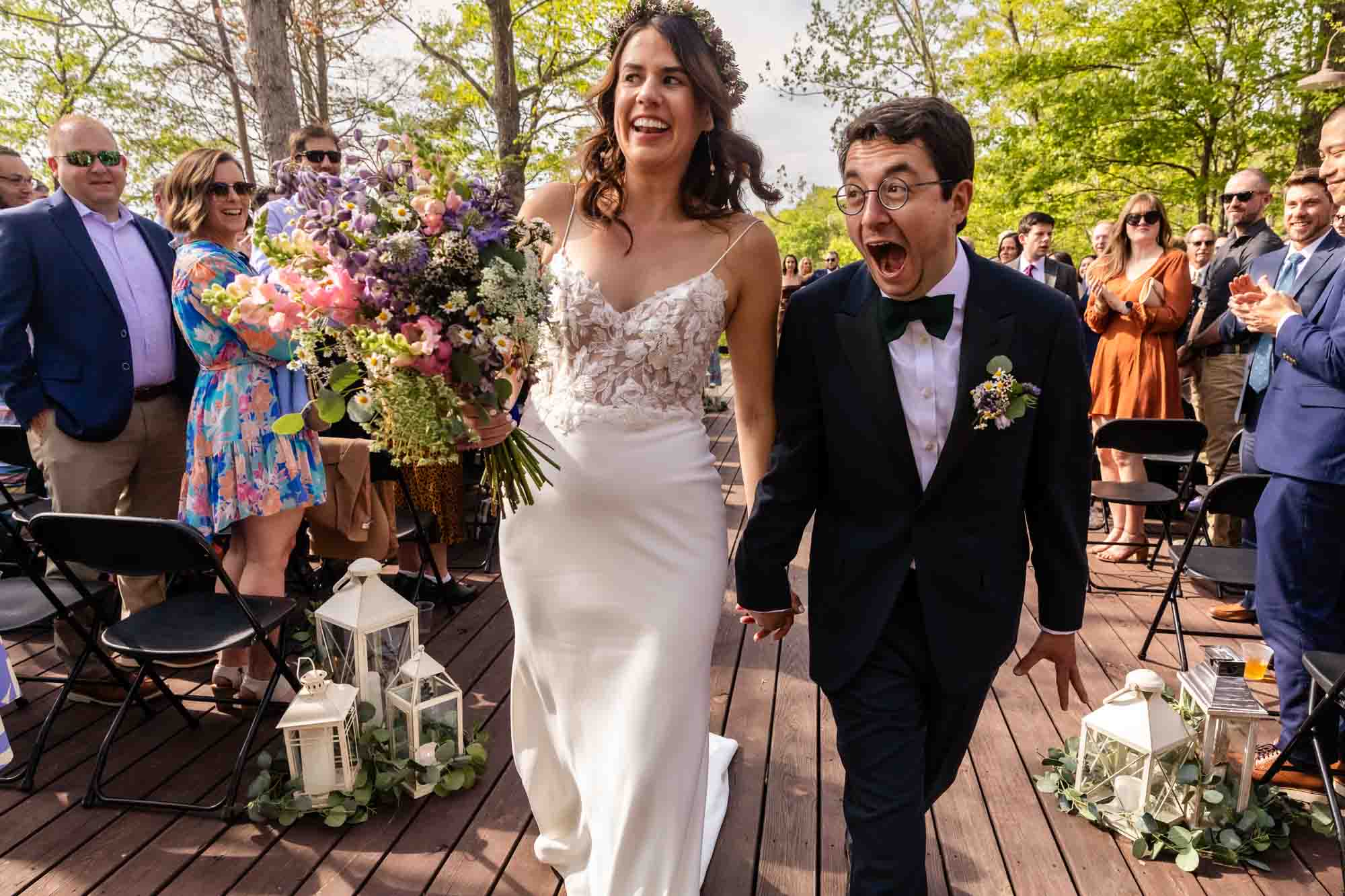 bride and groom celebrate wildly at their ceremony captured by documentary wedding photographer